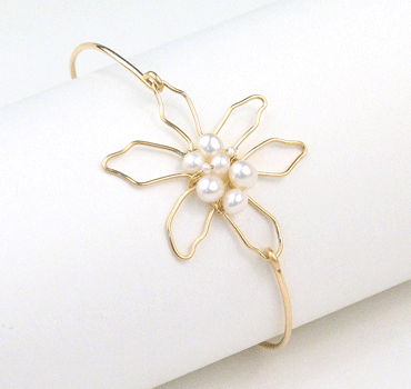 Flower silhouette and pearl cluster bangle bracelet